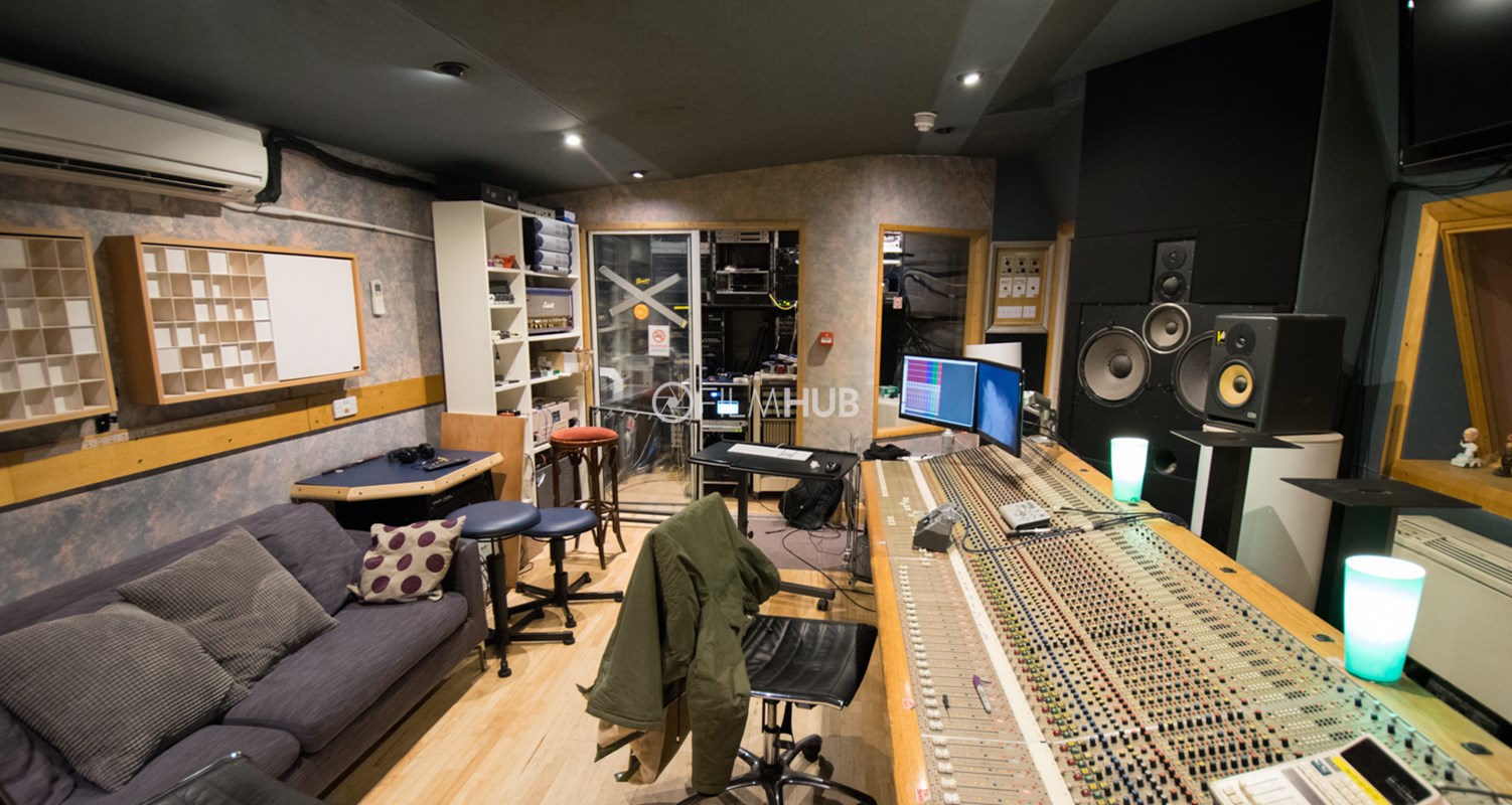 Modern recording studio with soundboard, ideal for music production workshops and events.