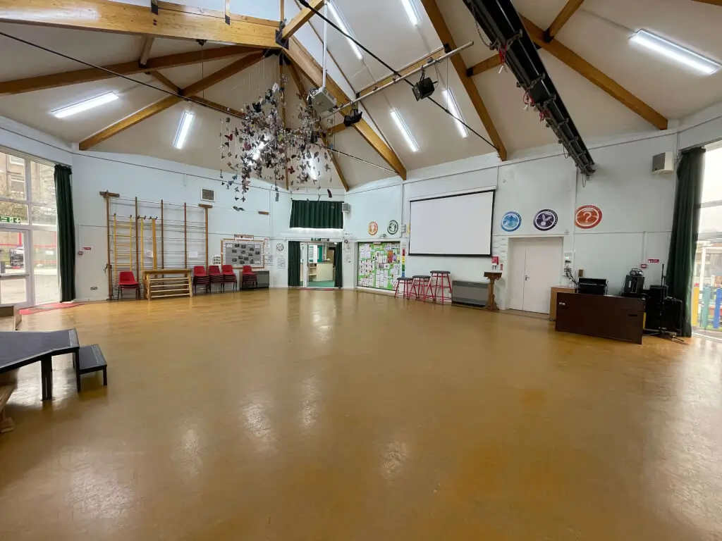 Versatile event space in St Peter’s Church Hall with high ceilings for meetings and workshops.