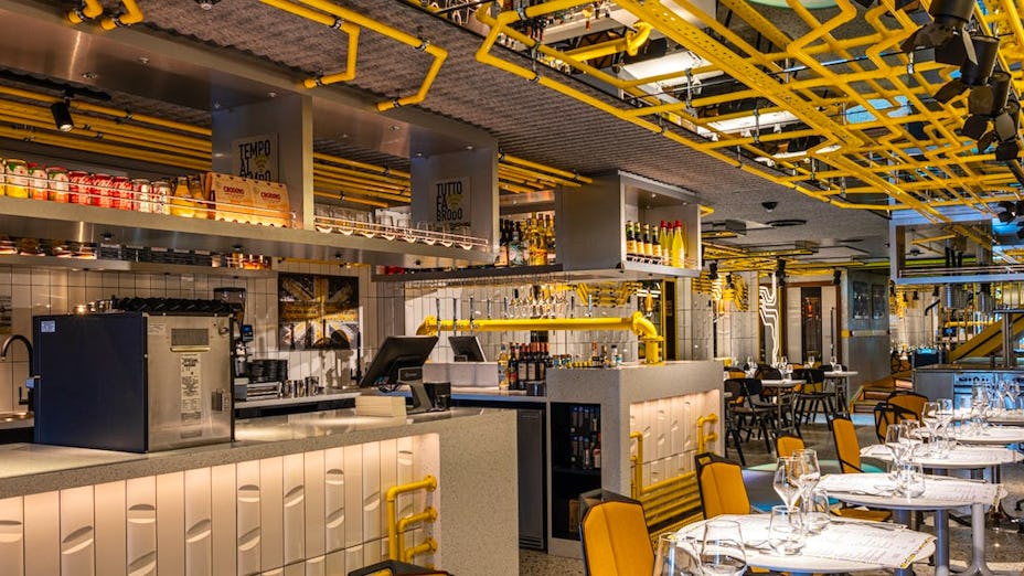Modern restaurant with yellow piping, ideal for networking events and casual meetings.