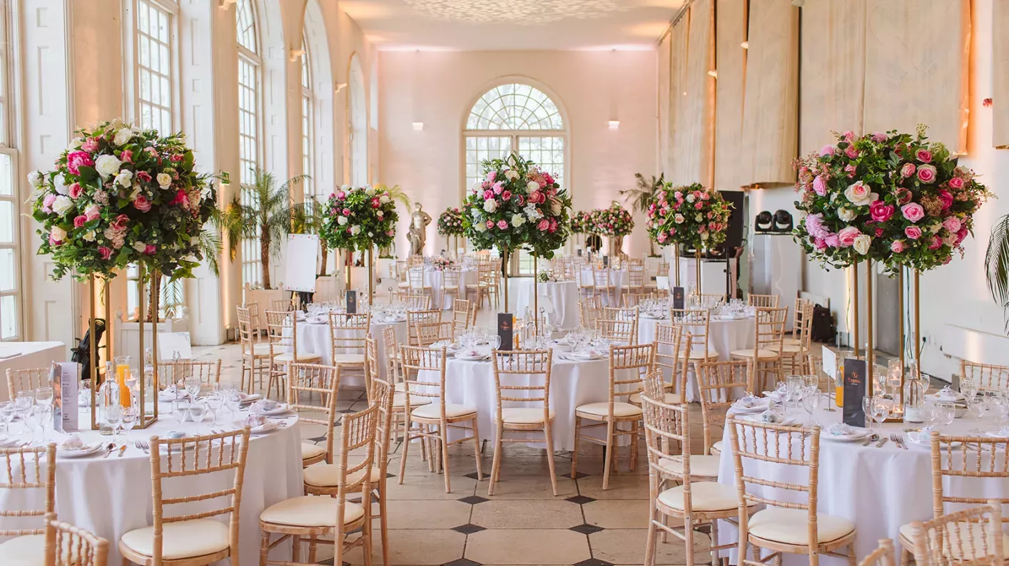 Banquet setup at The Orangery, Kew Gardens with elegant floral centerpieces for luxury weddings.