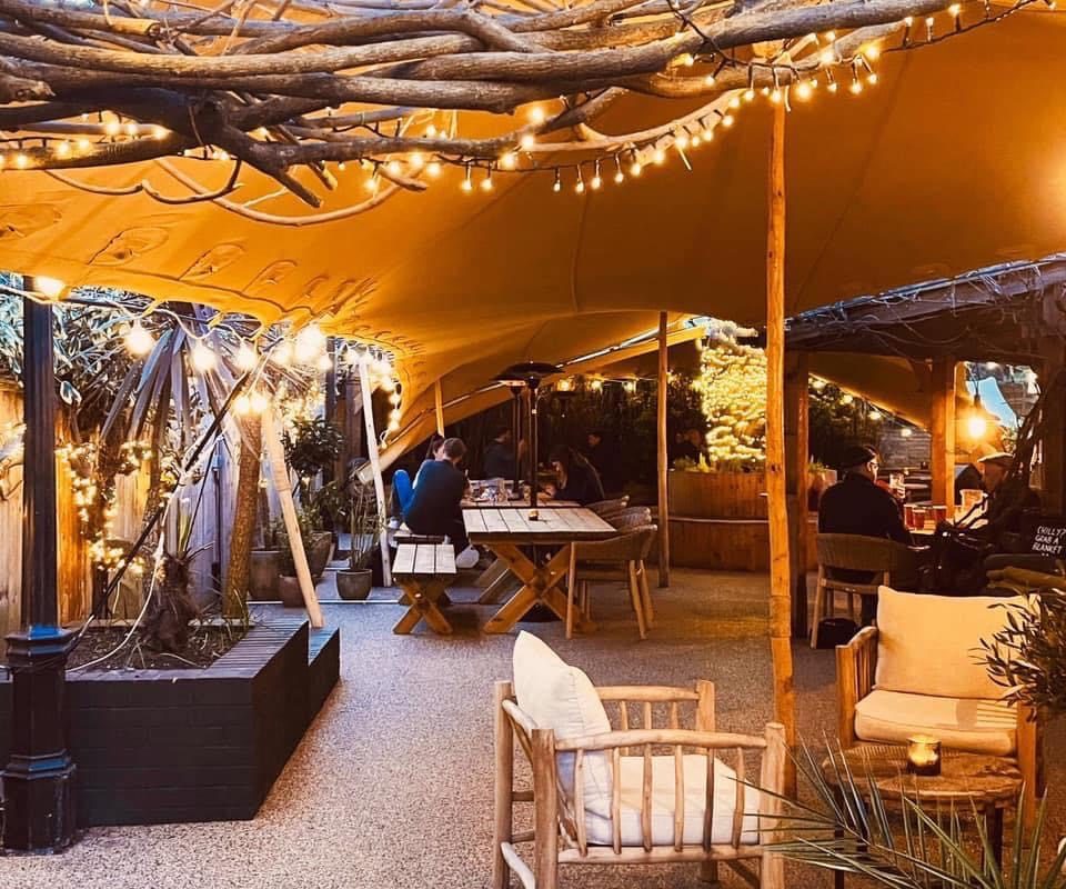 Cozy outdoor event space at The Lord Nelson with warm lighting for gatherings and networking.