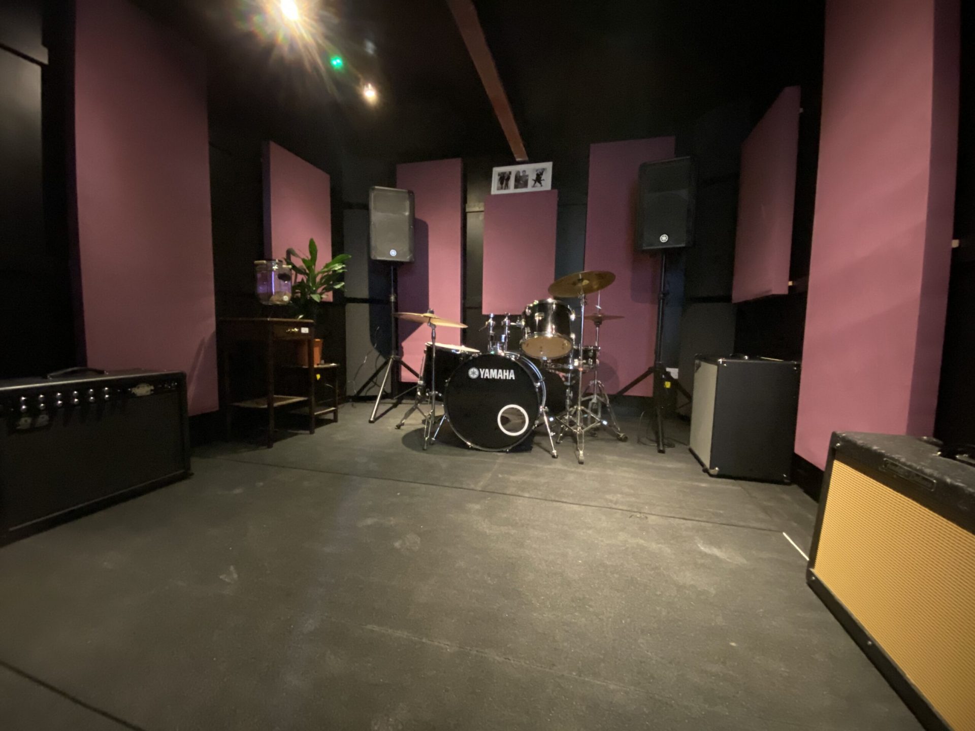 Soundproof recording studio with purple walls, ideal for music events and band rehearsals.
