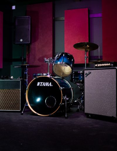 Recording studio with drum kit and amplifiers for live events and entertainment.