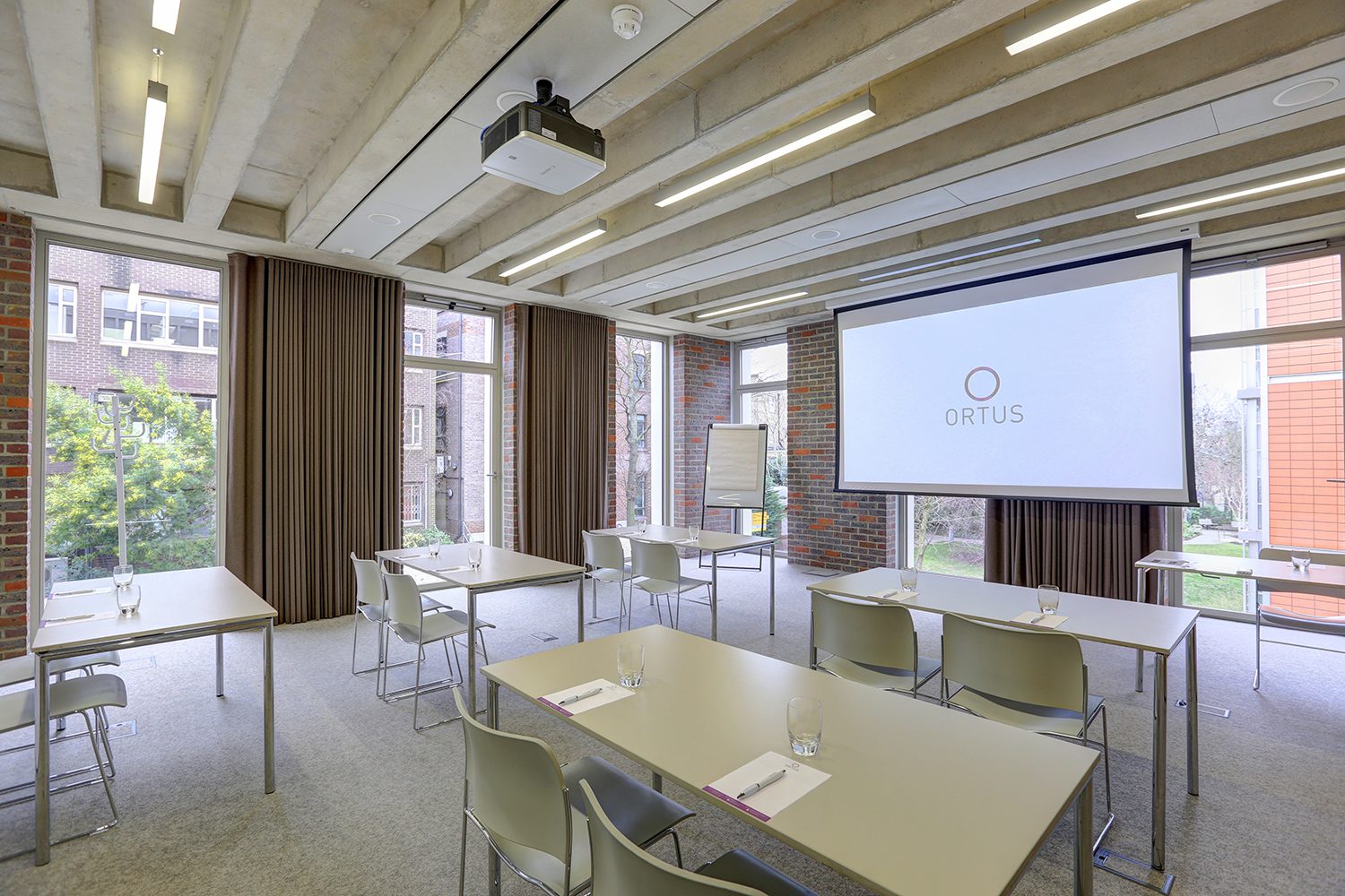 Modern meeting room with large screen, ideal for professional events and collaborations.