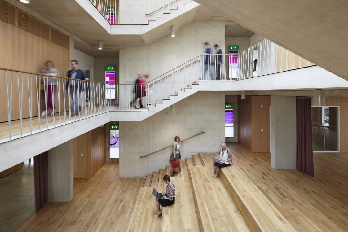 Modern meeting room with open staircase, ideal for networking events and workshops.