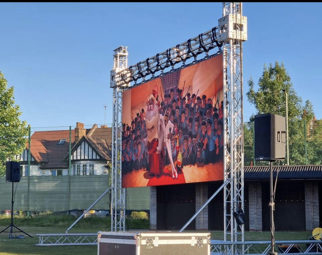 Outdoor cinema setup with large LED screen and speakers in Berkshire event venue.