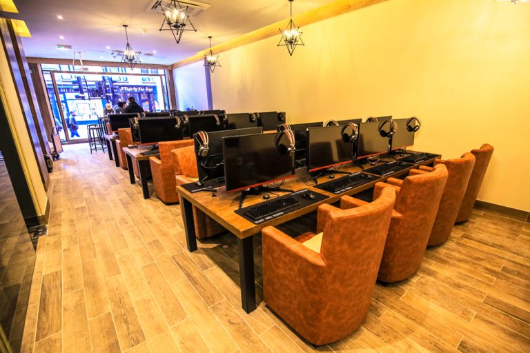 Modern games room with computer stations, ideal for tech workshops and gaming tournaments.