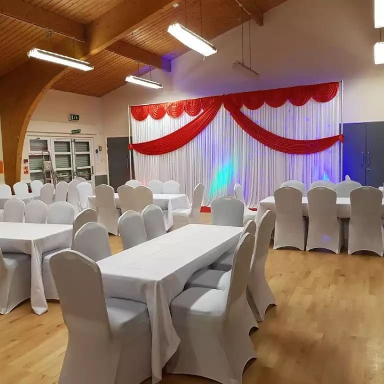 Event space at 2000 Community Action Centre with red and white drapery for weddings and gatherings.