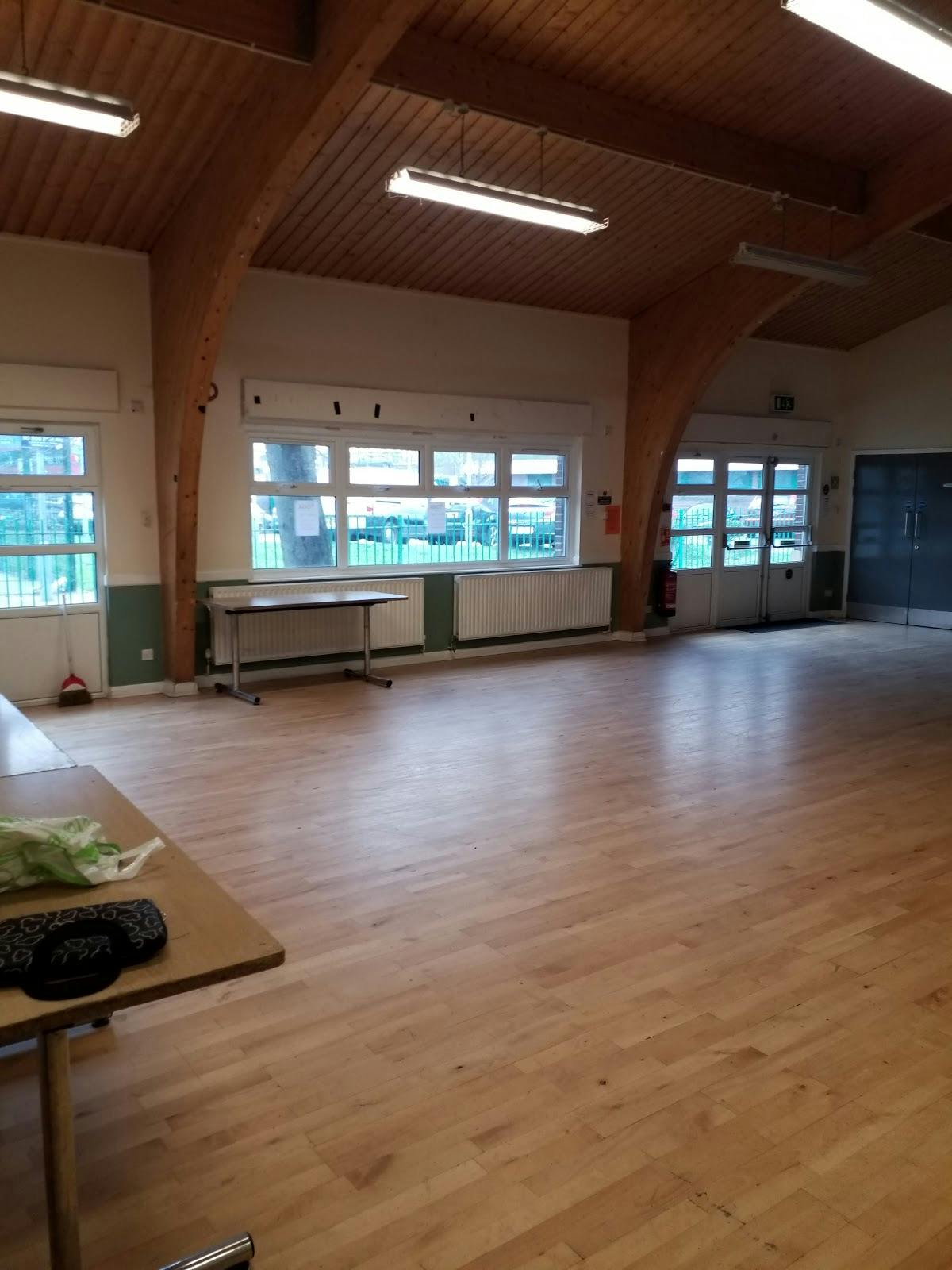 Versatile event space with wooden beams and natural light for meetings and gatherings.