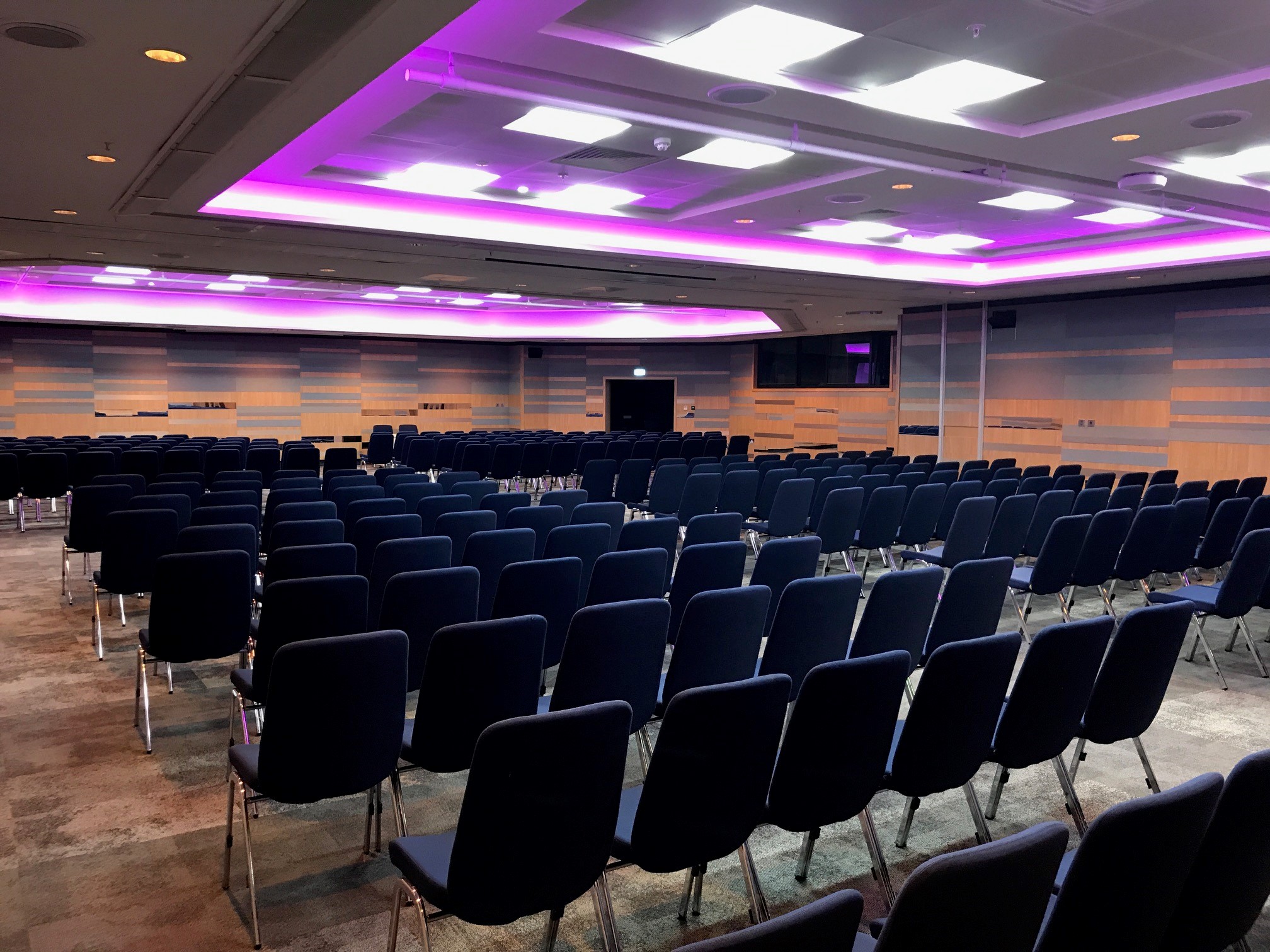 Hall 11a at ICC Birmingham: modern conference space with purple lighting for seminars.