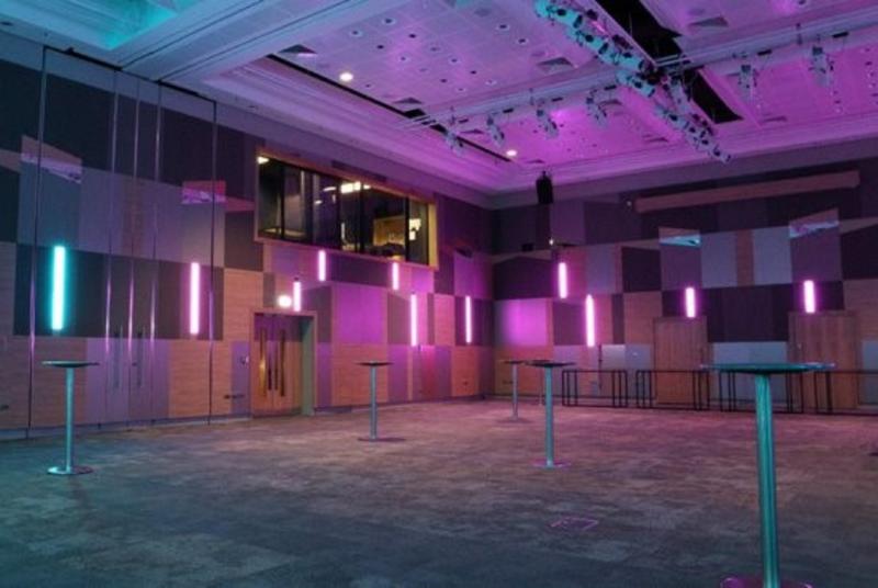 Versatile event space in ICC Birmingham with modern design and vibrant purple lighting.