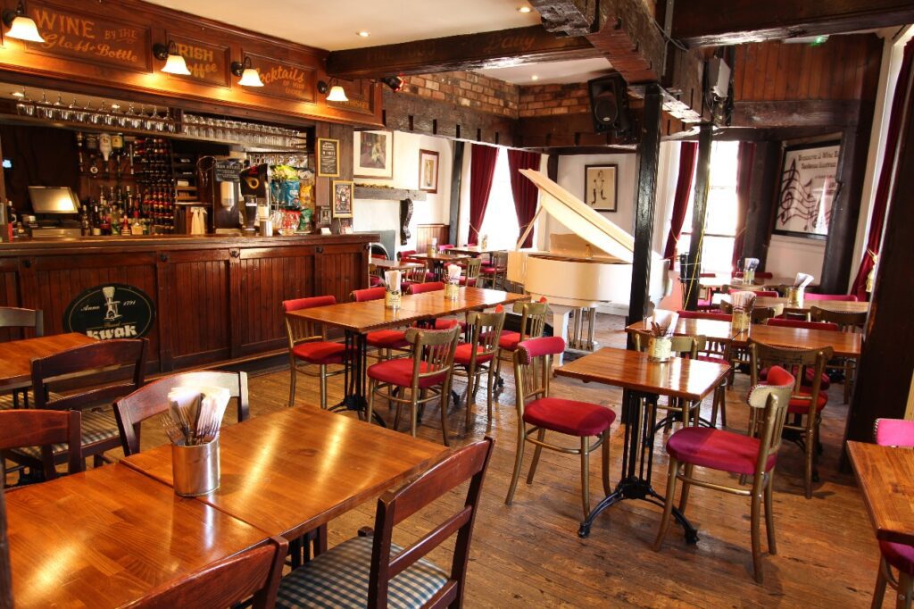 Piano Room in Toulouse Lautrec: cozy venue for intimate gatherings and live music events.