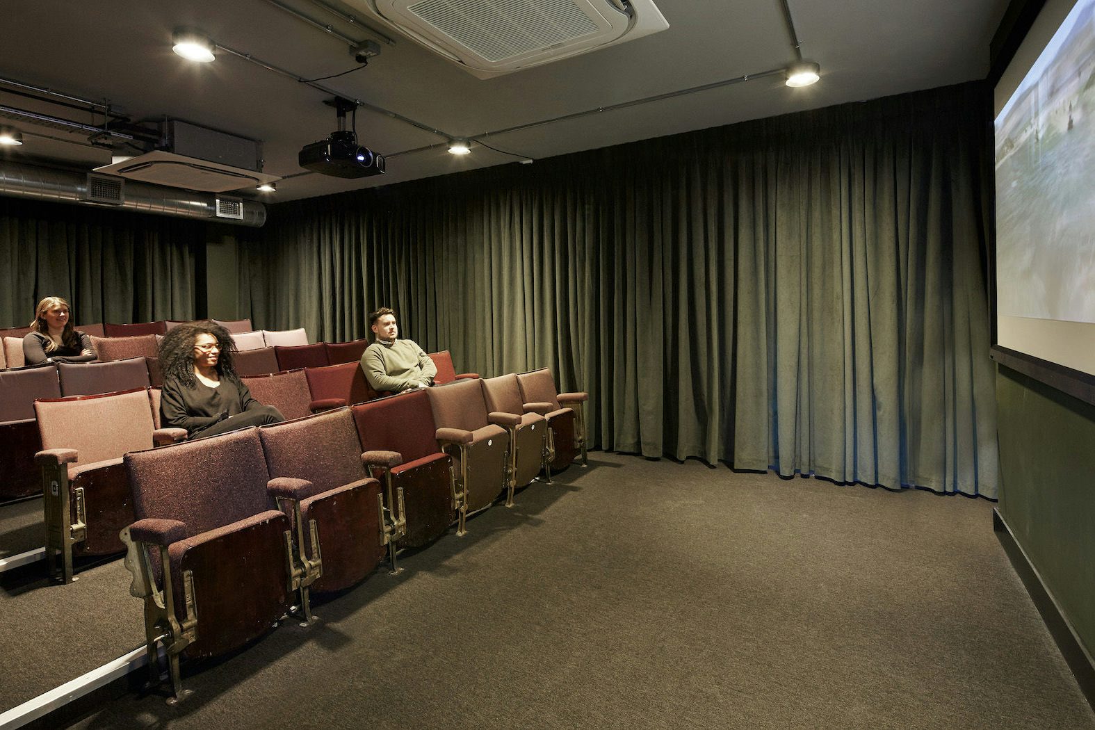 Intimate recording studio with tiered seating for corporate events and presentations.