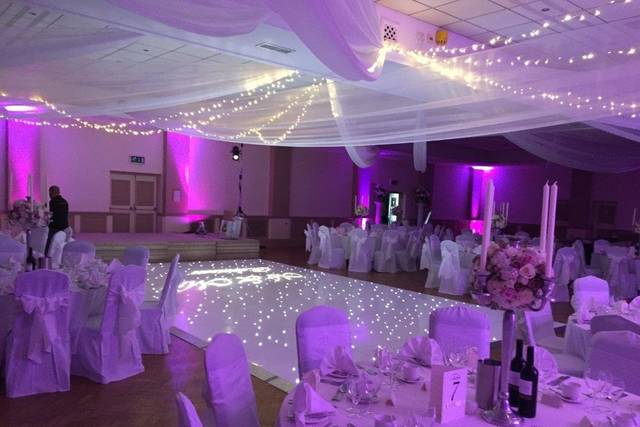 Elegant wedding venue at Oakley House with soft draping and twinkling lights.