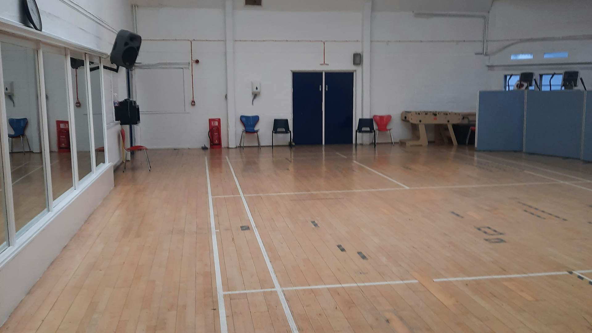 Spacious event space with polished floors, ideal for workshops and gatherings.