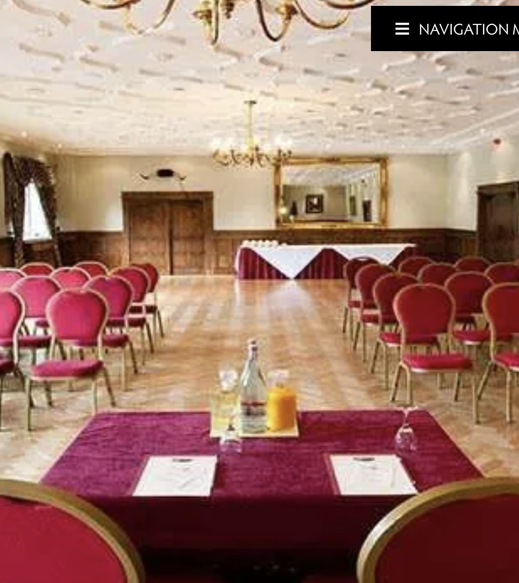 Miskin Manor Hotel meeting room with red chairs, perfect for seminars and presentations.