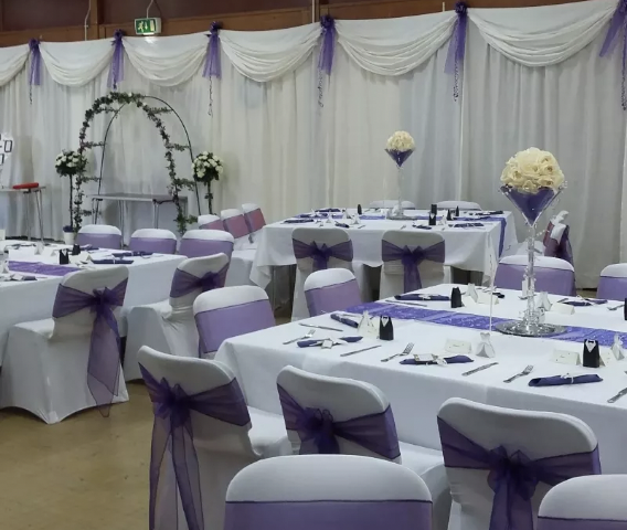 Elegant event space in EastendHomes, perfect for weddings with white and purple decor.