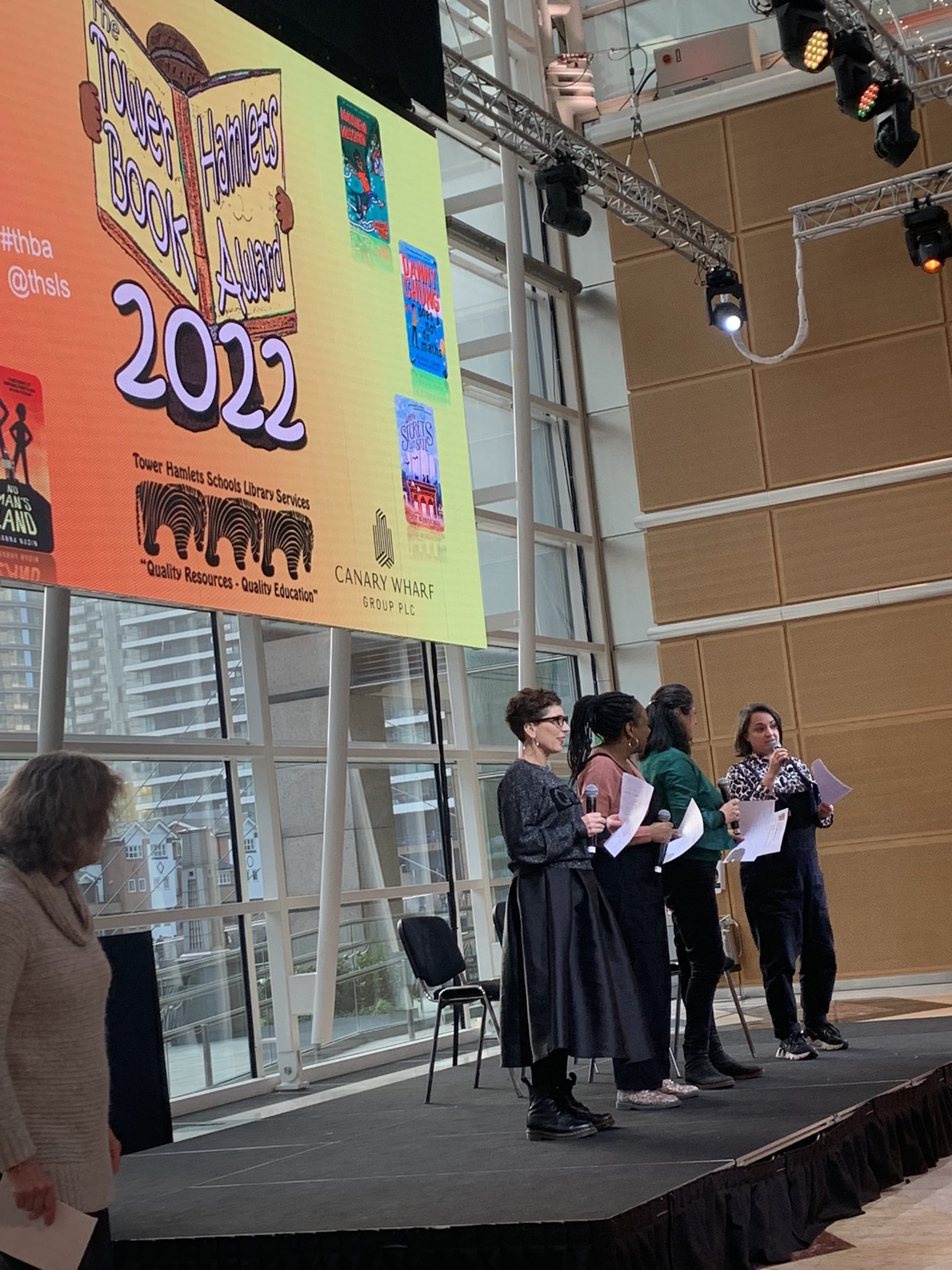 Morpeth School library event with vibrant stage, presenters, and networking opportunities.