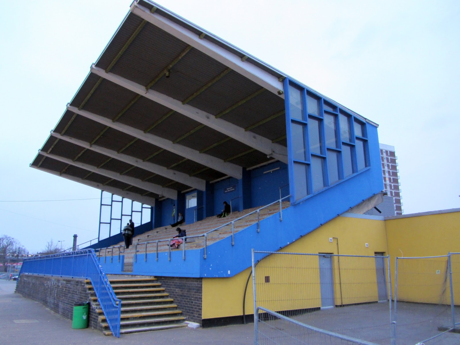 Modern athletics stadium with vibrant blue and yellow colors, ideal for outdoor events.