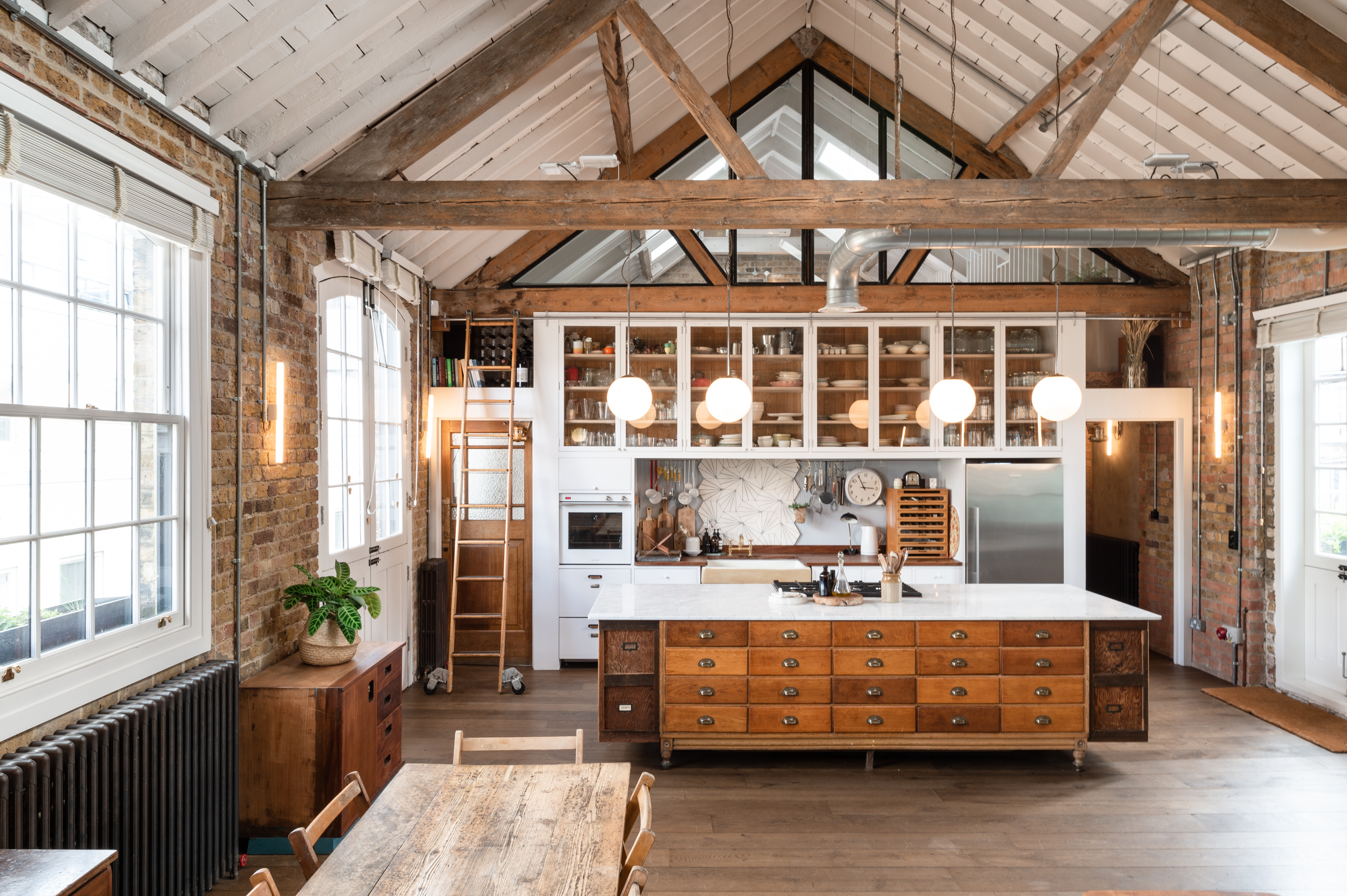 Spacious kitchen with rustic beams at Tastemade Studios, ideal for culinary events.