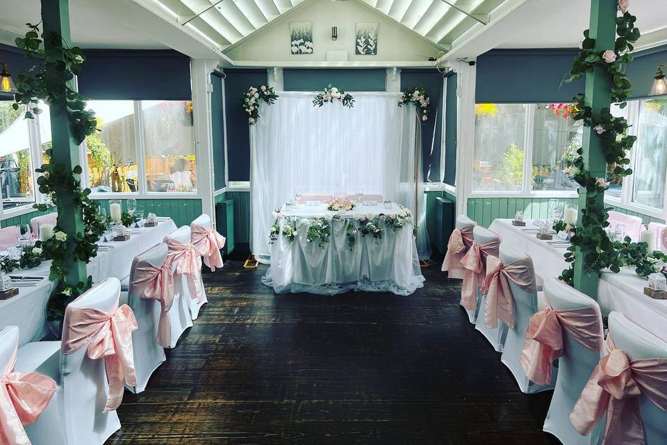 Elegant wedding venue in Twickenham with white and pink decor, perfect for celebrations.