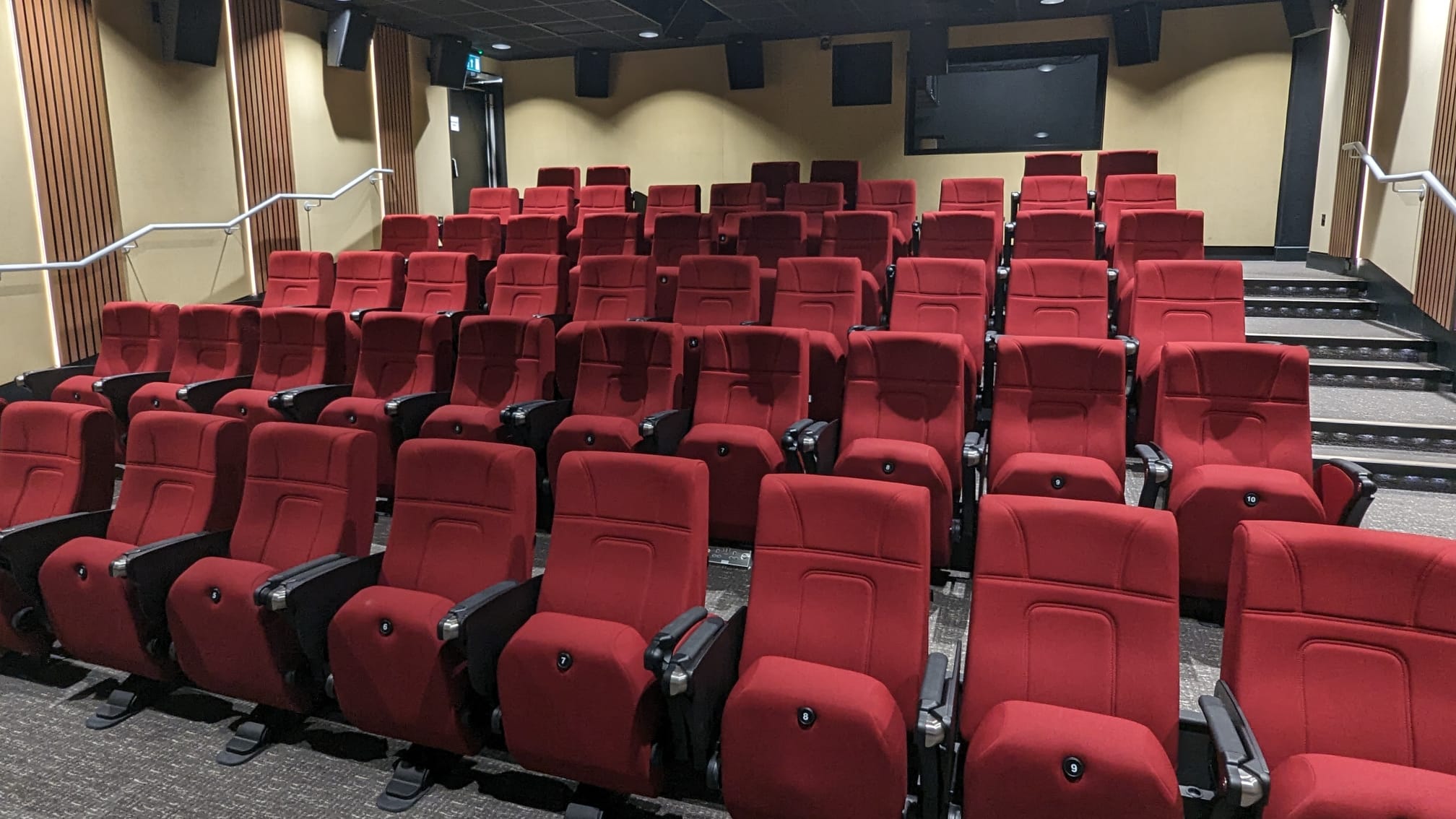 Recording booth in BLOC with plush red seating for presentations and screenings.