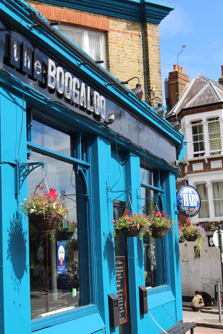Vibrant Boogaloo Pub exterior with blue walls, ideal for casual networking events.