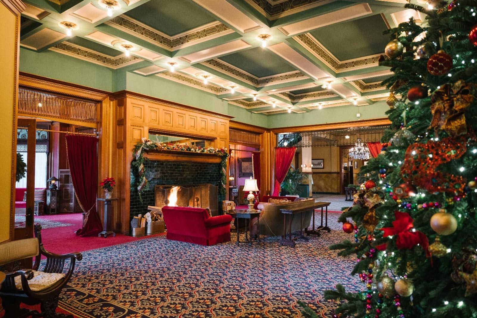 Elegant Castle Green lobby with fireplace, perfect for winter gatherings and events.