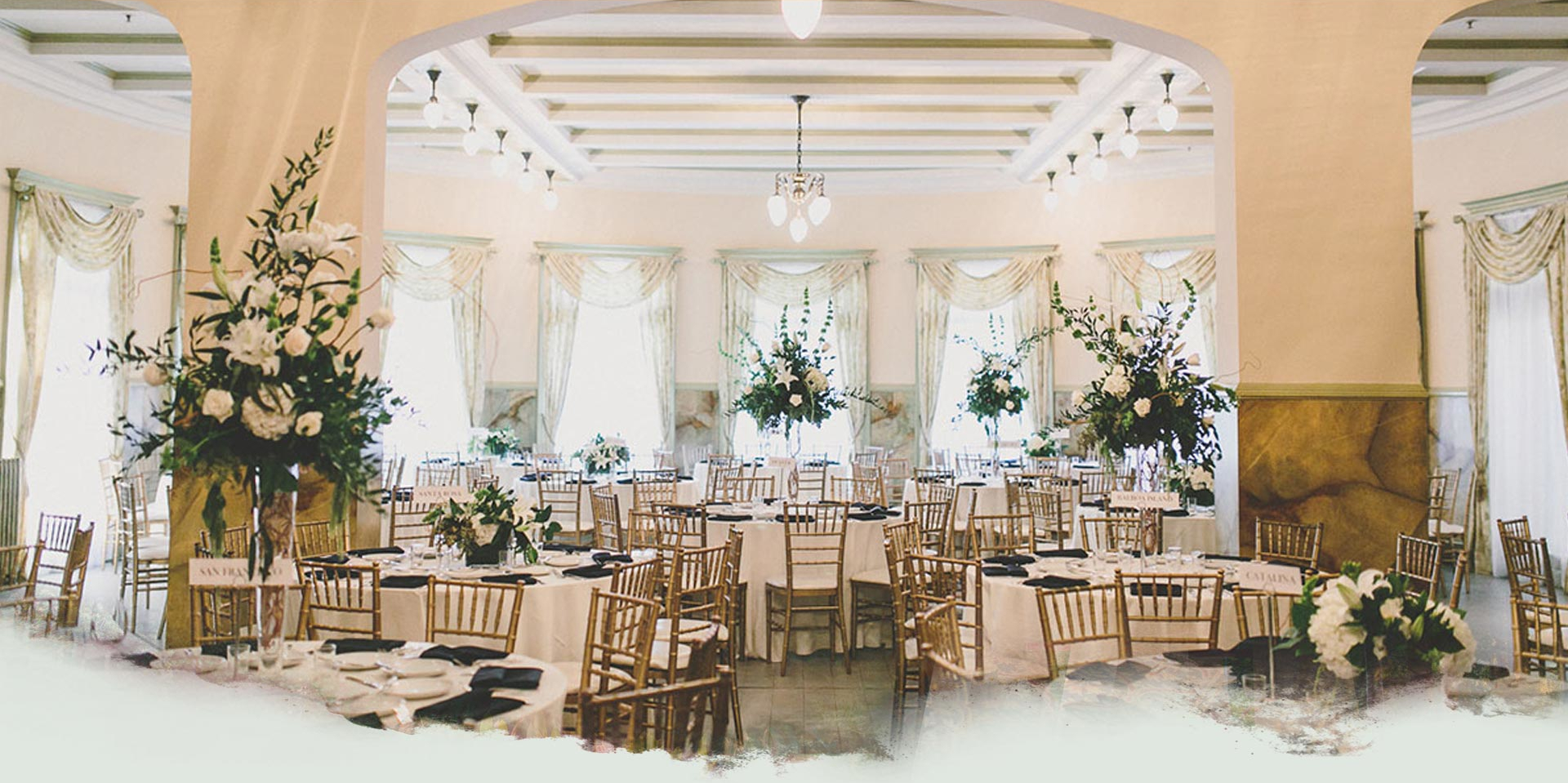 Elegant wedding venue with white tables and gold chairs in Castle Green's Terrace.