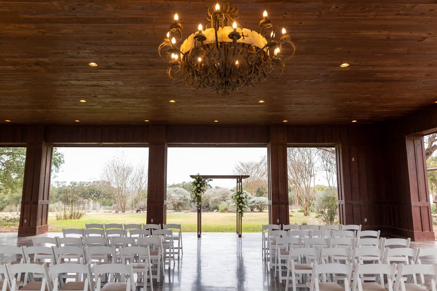Hofmann Ranch wedding venue with elegant wooden beams and floral arch for events.