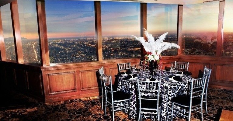 Elegant dining table at Pacific View Tower with city skyline, perfect for upscale events.