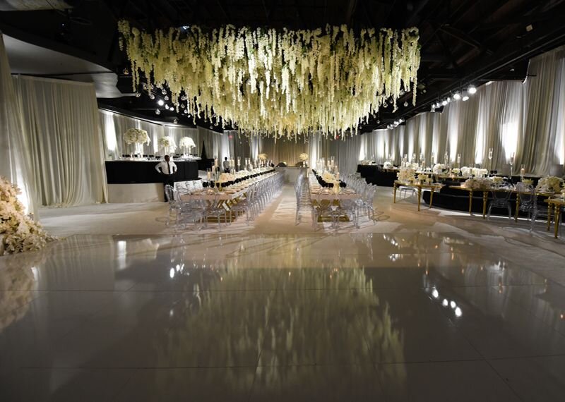 Elegant event space with floral installation, perfect for weddings and gatherings.