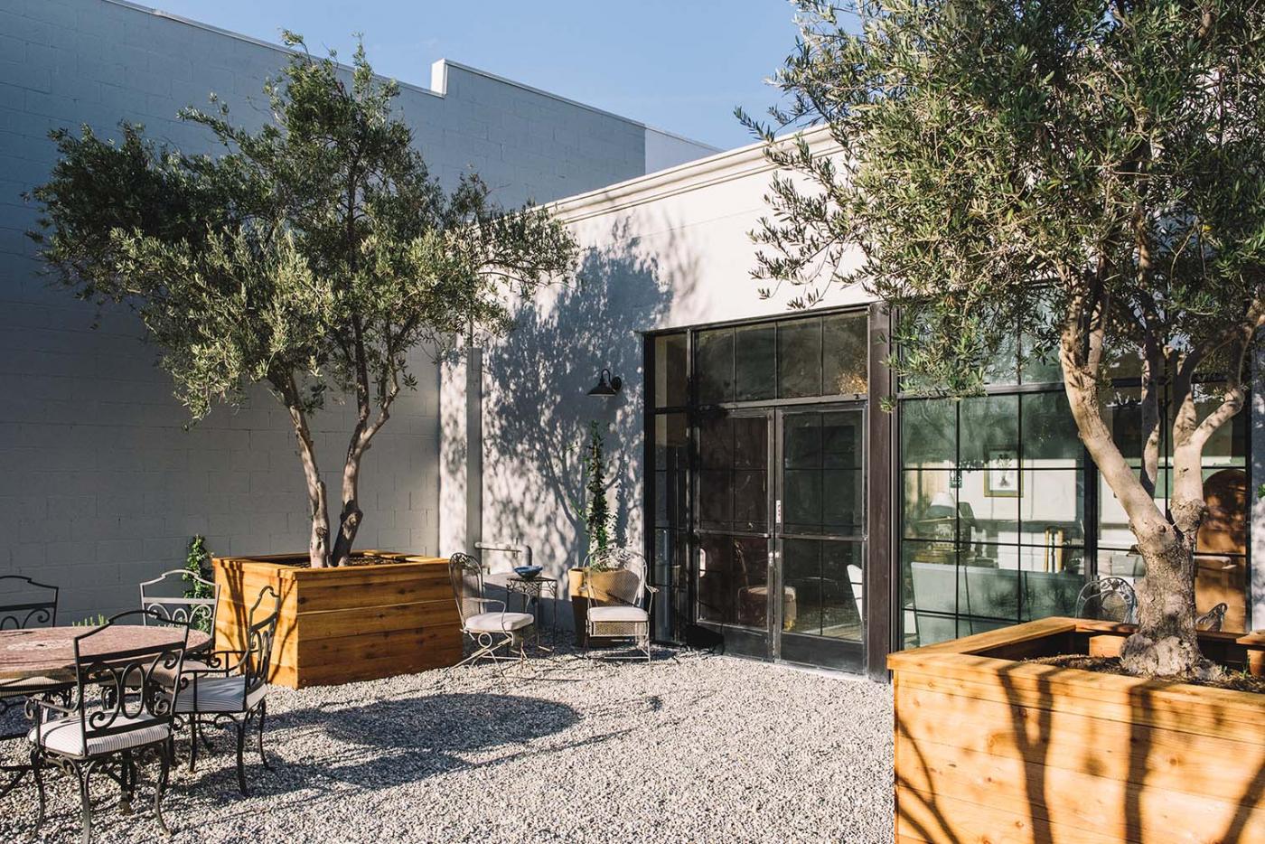 Charming outdoor garden venue with stylish seating for networking events and gatherings.