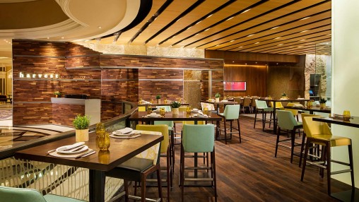 Modern dining lounge with warm wood tones, perfect for events and meetings.