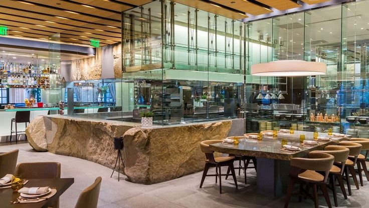 Modern upscale restaurant with glass walls, ideal for culinary events and private dining.