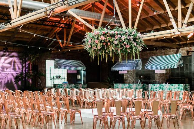 Art Gallery event space with rose gold chairs and floral decor, perfect for celebrations.