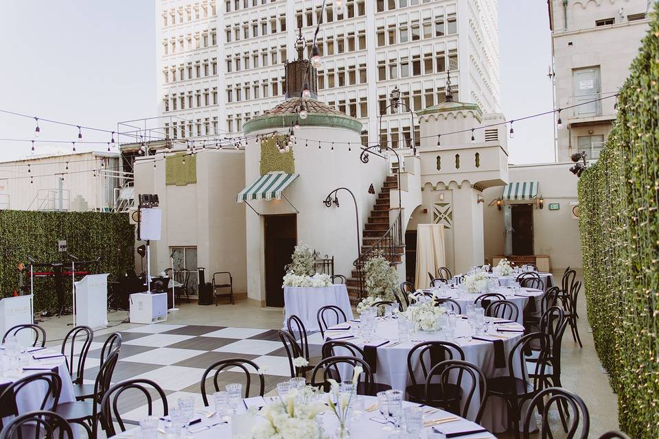 Stylish rooftop penthouse event space with floral decor, ideal for weddings and corporate events.