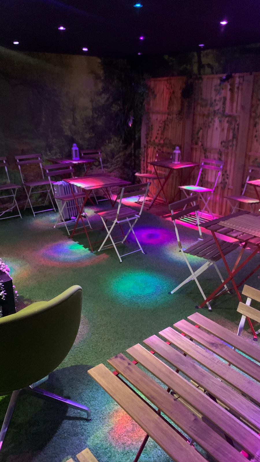 Vibrant Relaks radio cafe event space with colorful lighting for networking gatherings.