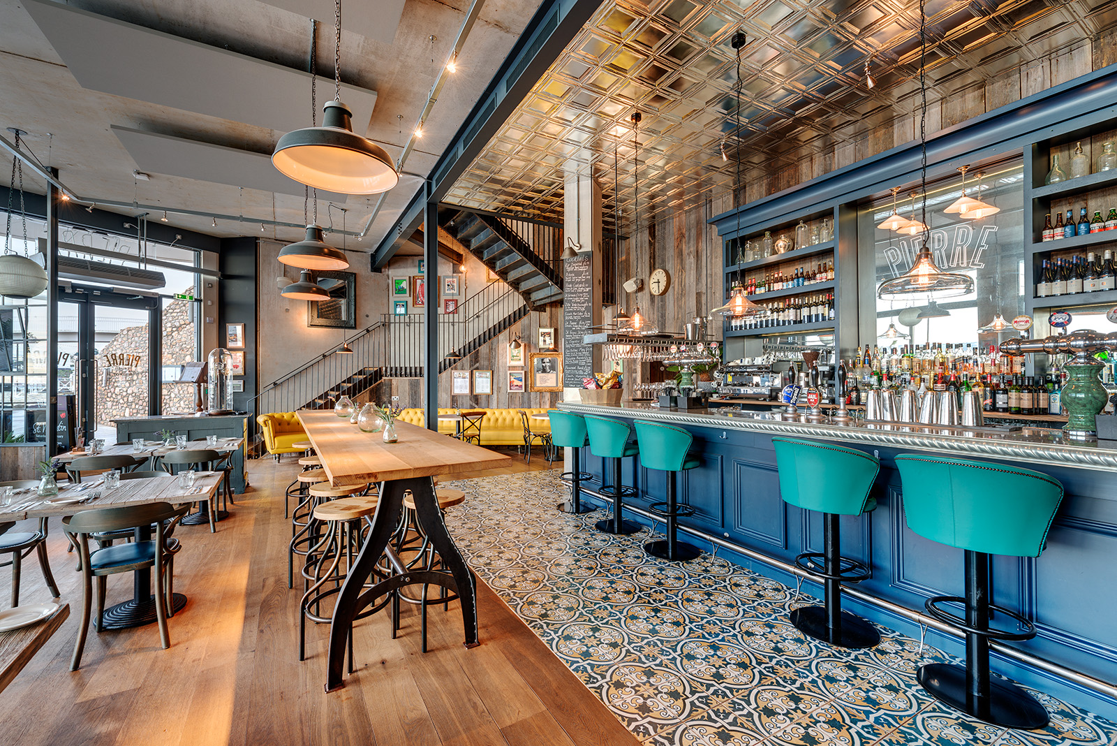 Stylish Bar Pierre with teal stools, ideal for networking events in Torquay.