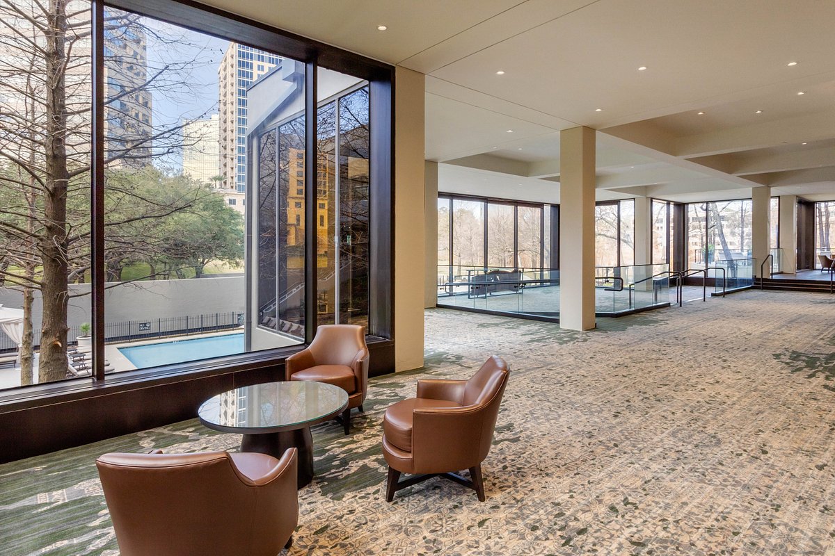 Palm Court at Omni Houston Hotel: modern meeting space with large windows for events.