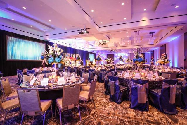 Post Oak Grand Ballroom at Omni Houston Hotel, elegant gala setup with floral centerpieces.