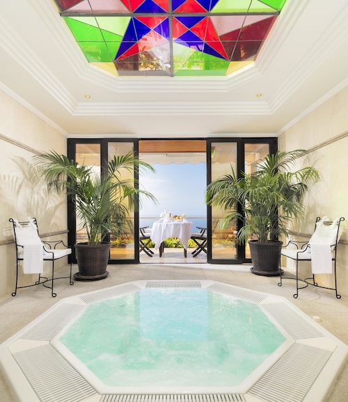 Luxurious hotel lobby with lush greenery, ideal for meetings and relaxation.