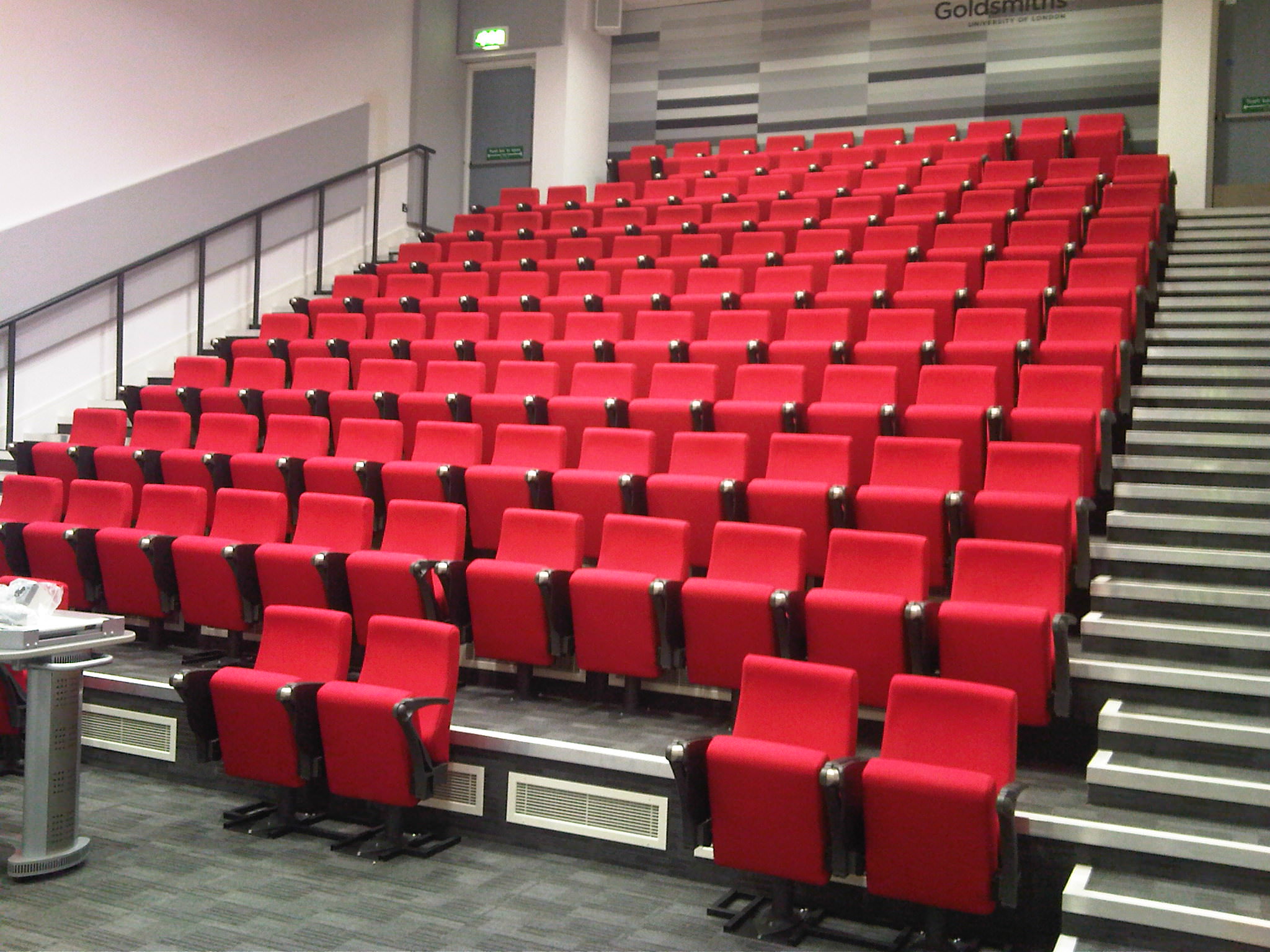 Goldsmiths University lecture theatre with red seating, ideal for conferences and seminars.