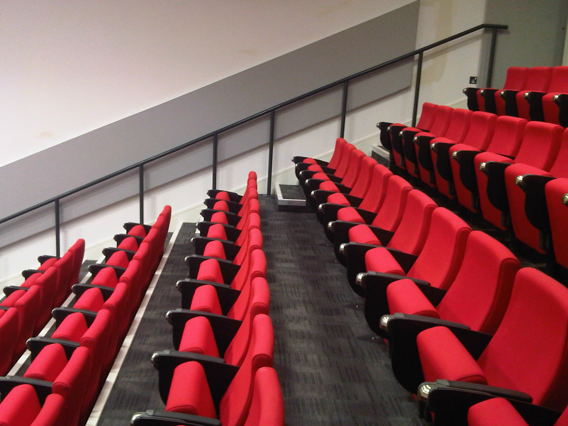 Goldsmiths University lecture theatre with vibrant red seating for presentations and events.