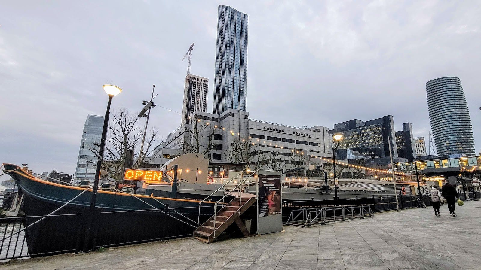 Vibrant waterfront event space with modern skyline, ideal for networking and gatherings.