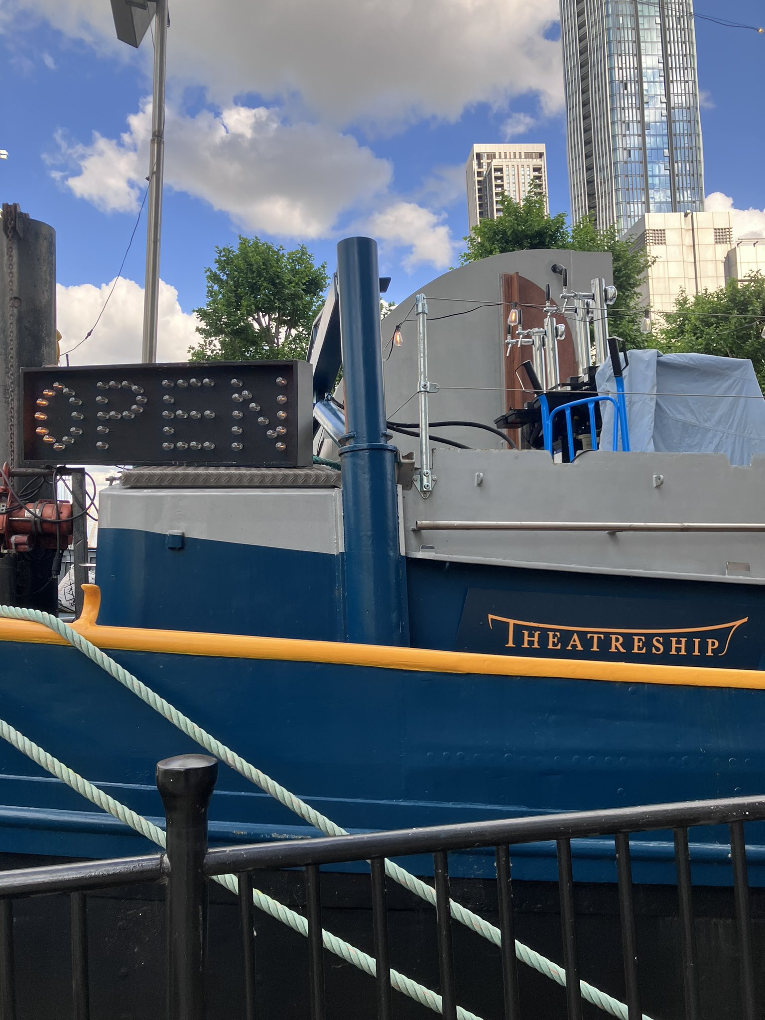 Event Space on Theatreship with illuminated "OPEN" sign for unique gatherings.