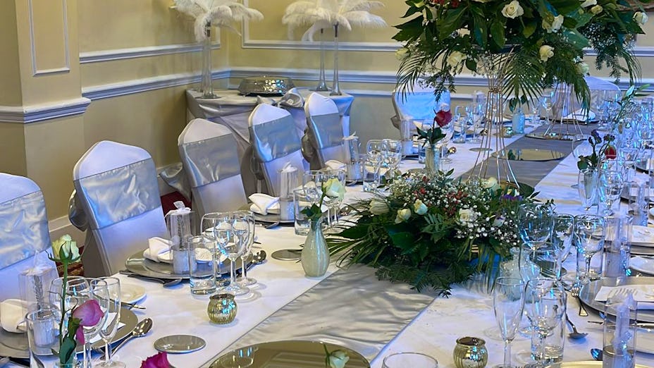 Elegant banquet table with floral centerpieces at West Lodge Park Hotel for weddings and events.