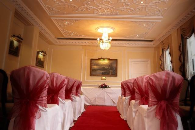 Elegant Banqueting Room with red sashes, ideal for meetings and ceremonies at West Lodge Park.