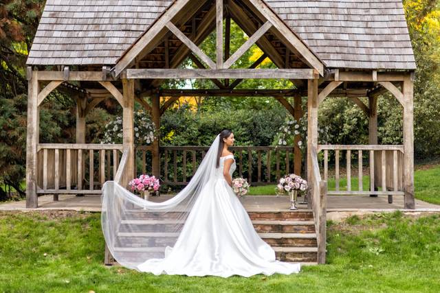 Outdoor wedding venue at West Lodge Park Hotel with charming gazebo and floral arrangements.