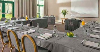 Morgannwg Suite meeting room with U-shaped tables, ideal for professional events and workshops.